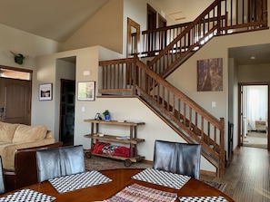 Dining room with staircase up to loft and two more bedrooms.
