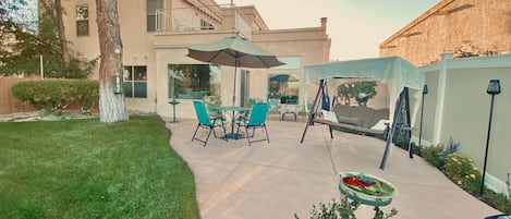 Beautiful private back patio with table, glider, fountains, bird feeders, BBQ