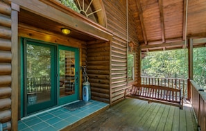 Enjoy the porch swing  overlooking the expansive front yard and all the trees