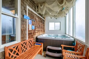 Enclosed spa with frosted glass accommodates six guests