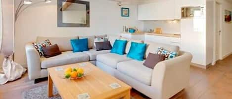 Very comfortable sofa and well equipped American style kitchen.