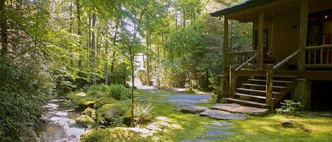 Front porch of Waterfall cabin with view of stream and waterfalls
