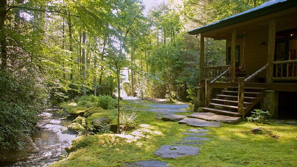 Front porch of Waterfall cabin with view of stream and waterfalls
