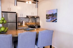 kitchen with gas range and bar seating for 3.