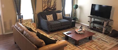 Living room. Relax and enjoy at the sofa with wifi and 50 inches TV with cable.