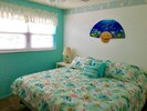 King size bed in our Florida style bedroom.