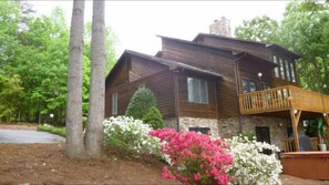 Backside of home with hot tub