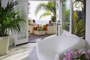 INTERIOR LOOKING OUT TOWARD DECK & OCEAN