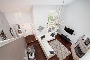 2 level living rooms with lots of windows and skylight on 2nd floor