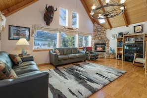 Living room with large smart TV and vaulted ceilings