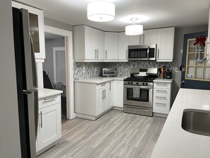 New (2020) flooring, SS appliances, countertops, backsplash.