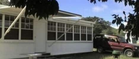 Exterior: patio, table benches, BBQ, awning, SUV
