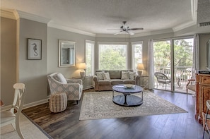 View of living room showing queen sleeper sofa.