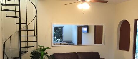 Living room, spiral staircase to rooftop veranda.