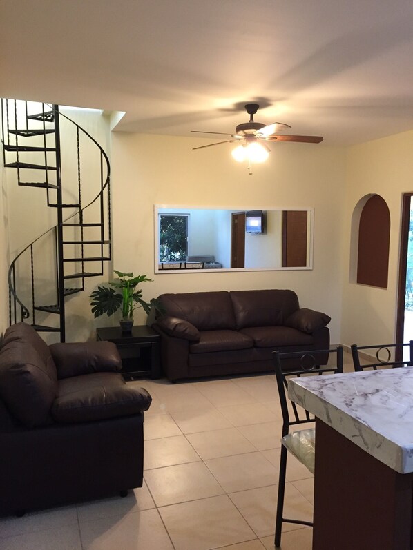 Living room, spiral staircase to rooftop veranda.