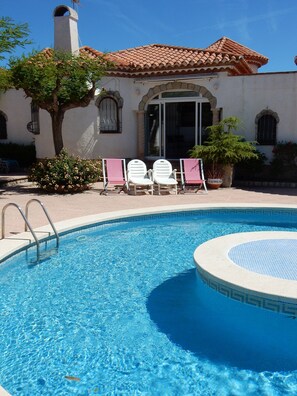Loungers an Deckchairs between the villa and Community Pool. 
