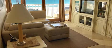 Living room with oceanfront balcony.  Smart LED TV, DVD player