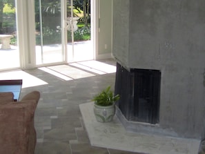 The open concept floorplan has rooms that wrap a central 6-sided fireplace.