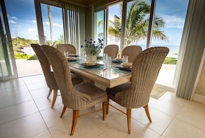 The dining table has double-fronted views of the whole beautiful bay.