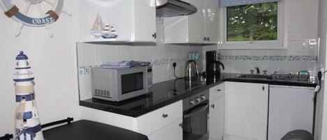 Bright fully fitted kitchenette with oven, hob, microwave, fridge etc