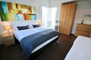 Bedroom 1 has a contemporary style with an amazing river and mountain view.