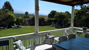 View from the veranda onto the enclosed garden and mountains in the background