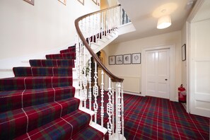 The elegant staircase in the entrance hall with Fraser dress tartan