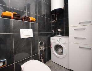 Washing machine situated in bathroom