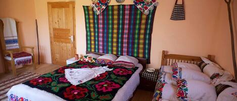Our Triple Room shows hand made Maramures bed covers, wall hanging & pillowcases