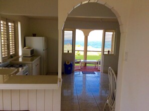 Open plan living area with well equipped kitchen.