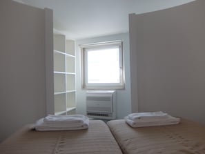 Second bedroom with two singles beds. Can be transformed in a queen size bed.