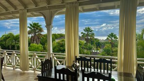 The balcony is wide with a seating and dining area to enjoy her view 