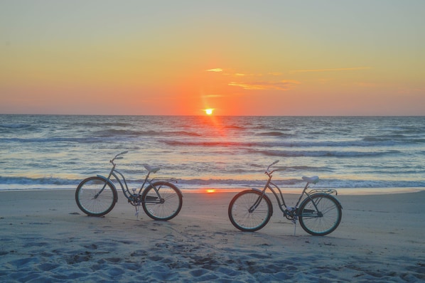 The sunrise in your private beach and two bicycle cruisers.