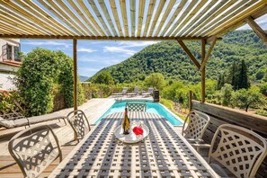 Large Iron table (seats 8) looking onto pool from decked area