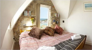 The enormous bed is 8 ft wide and the views from the window are amazing