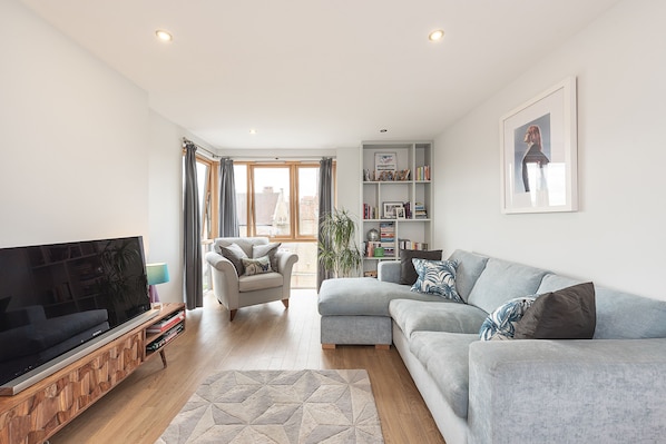 Beautiful spacious living room with 42' screen, Apple TV and interesting books