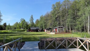 Blick vom Steg auf das Gartenhaus rechts und das Haupthaus geradeaus