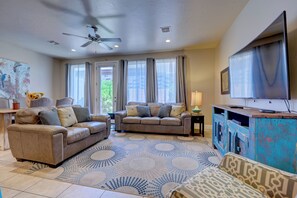 Large open living room and dining area with access to private back patio