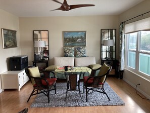 Front room with couch/bed , round table and tv.  Also a large table not shown.