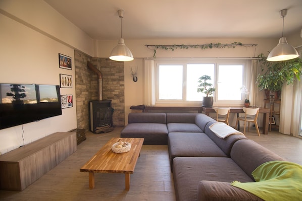 The living room with a large comfortable sofa. Can fit 8 people.