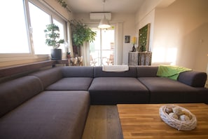 The living room with a large comfortable sofa. Can fit 8 people.