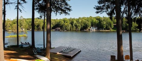 Waterfront with fire pit and dock.