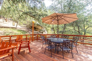 Large redwood deck, propane BBQ, table & chairs with umbrella, lounge chairs.