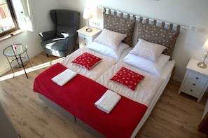 A large double room with spacious bathroom and access to a 70m2 roof terrace.