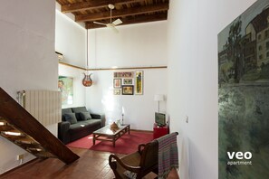 View towards: living area. With high wood beamed ceilings, terracotta flooring.