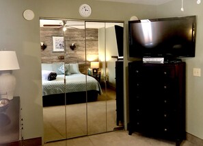 Large screen cable TV/Roku/DVD player in king bedroom.