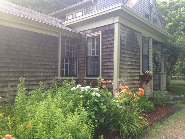 Side garden and entrance leads to the entryway. Driveway can accommodate 4 cars.
