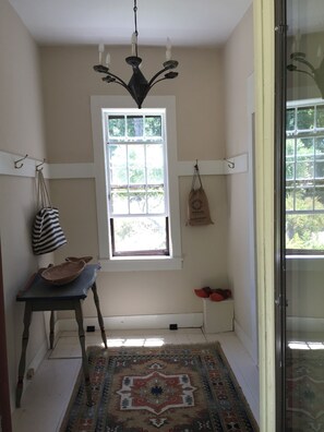 The side entryway with hooks for beach bags, etc. leads into the dining room
