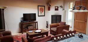 Open living area: Cable TV & Wifi.  Wood-burning fireplace behind chair to right