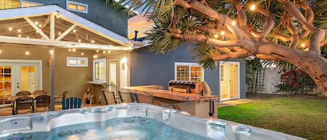 Our beautifully lit backyard, including a clean and spacious jacuzzi.